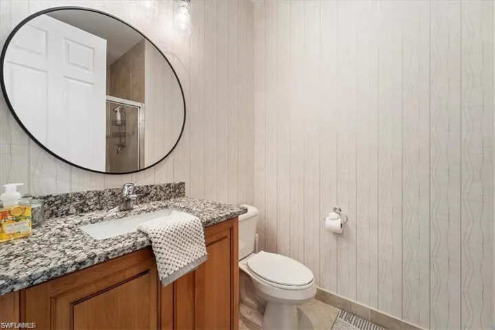 Bathroom featuring vanity, a stall shower, and tile patterned floors