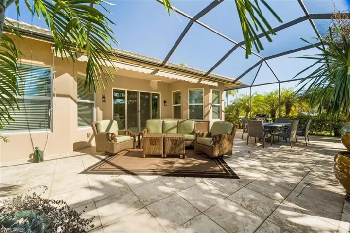 View of patio featuring a sunroom, outdoor lounge area, outdoor dining space, and a lanai
