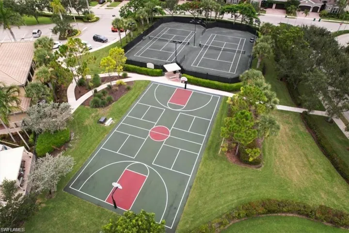 View of sport court featuring community basketball court and a lawn