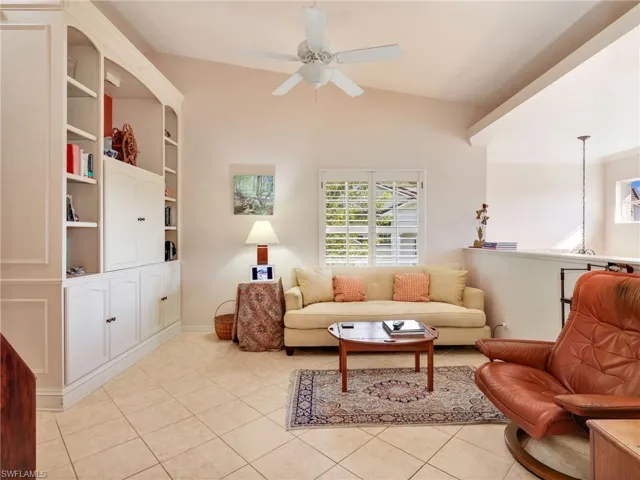 Flex/Den/Office area featuring light tile patterned flooring, pocket doors, built in cabinetry, and recessed lighting