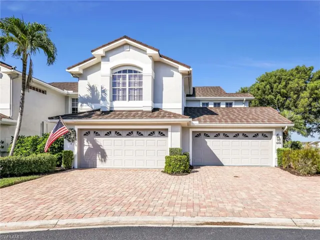 View of front of property with stucco siding, a garage, and decorative driveway