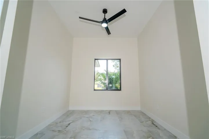 Empty room featuring ceiling fan