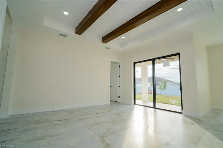 Unfurnished room with wood ceiling, a towering ceiling, and beamed ceiling
