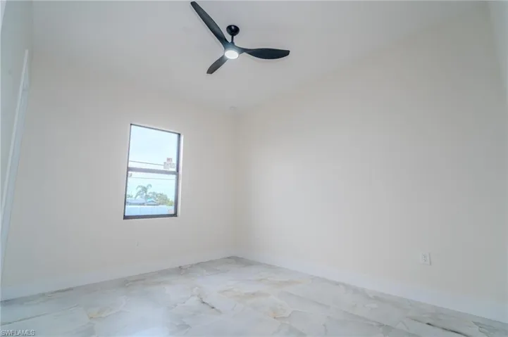 Unfurnished room featuring ceiling fan
