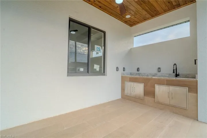 View of patio with ceiling fan and sink