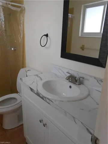 Full bathroom featuring toilet and a shower
