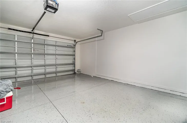 Garage with electric garage door opener and epoxy flooring
