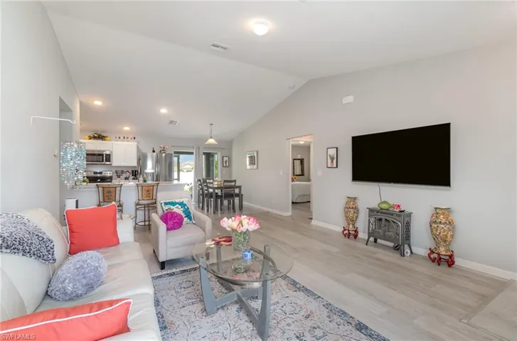 Living room featuring luxury vinyl plank flooring and vaulted ceiling