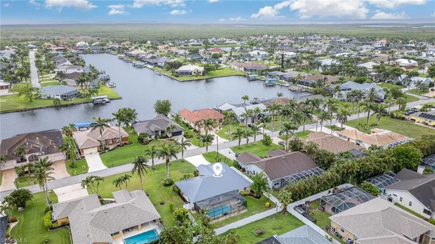 Aerial view of residential area featuring large Gulf Access Canal across the street