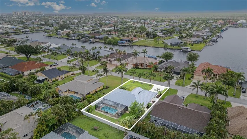 Aerial view of residential area featuring Gulf access propertys across the street and property boundaries highlighted