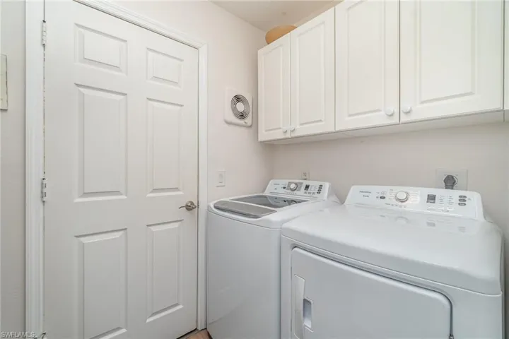 Laundry room with washer and dryer and cabinet / storage space