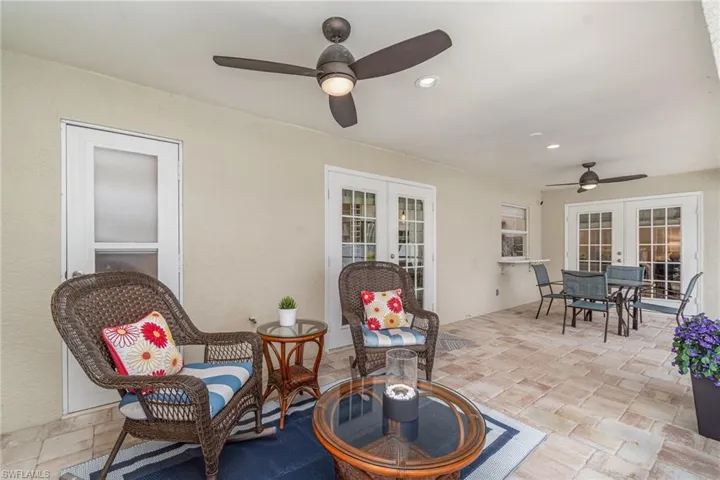 View of large lanai with french doors and ceiling fan