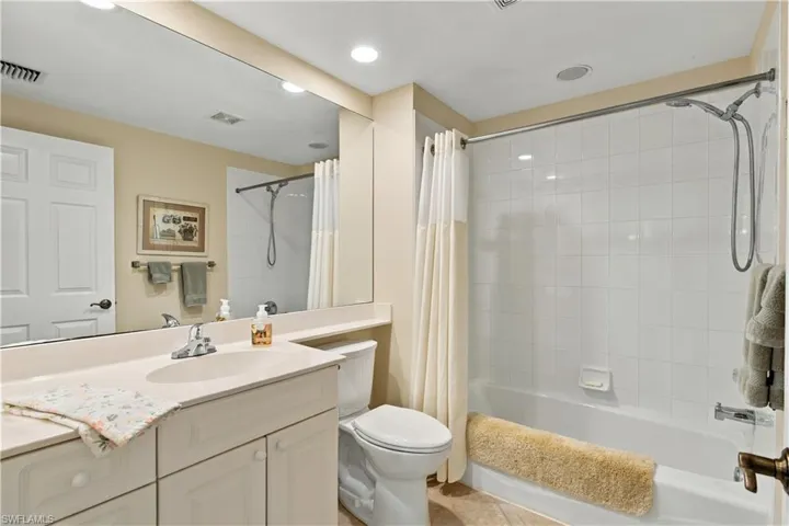 Guest bathroom located next to the guest bedroom with tub/shower combination.