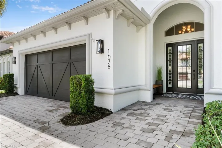 View of exterior entry with 2 car garage
