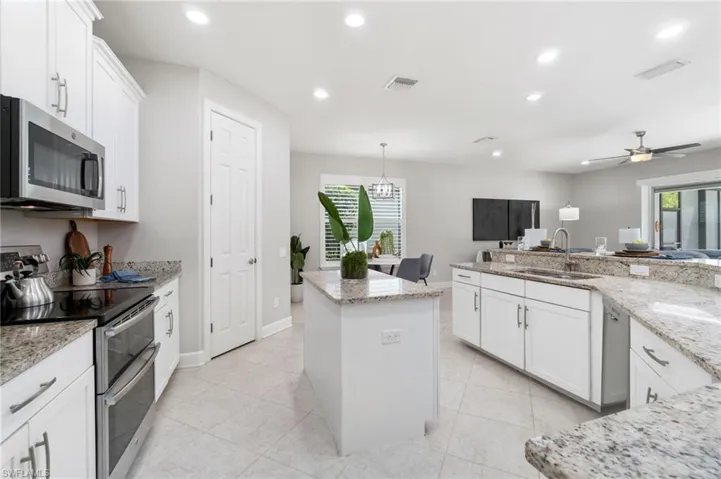 Kitchen featuring sink, appliances with stainless steel finishes, a wealth of natural light, and ceiling fan