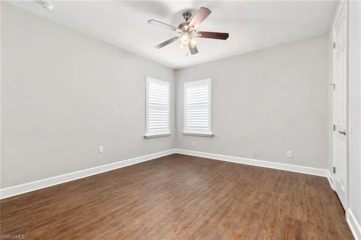 Dual en-suite Bedroom 2 featuring ceiling fan and hardwood / wood-style floors