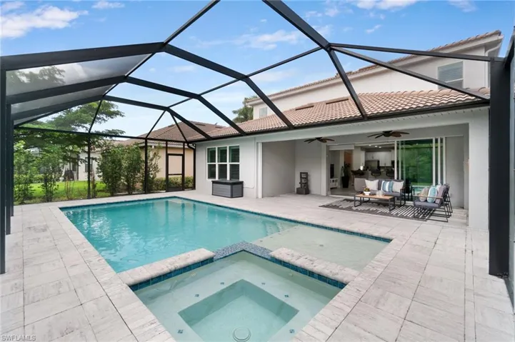 View of NEW saltwater pool/spa with sun deck, fountain and expansive modern paver patio area including a large shaded area.