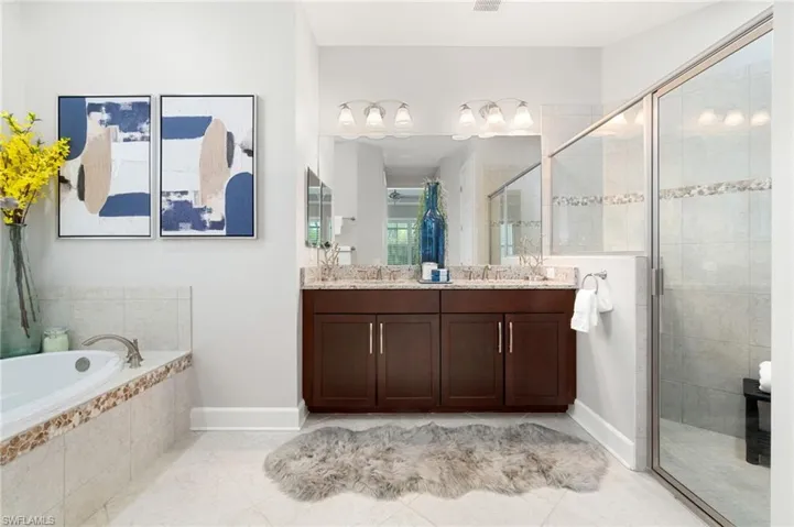 Primary Bathroom with dual vanity, shower with separate bathtub