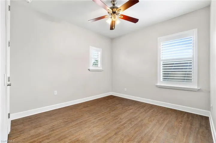 Unfurnished bedroom 4 with ceiling fan and hardwood / wood-style flooring has attached Jack and Jill bathroom