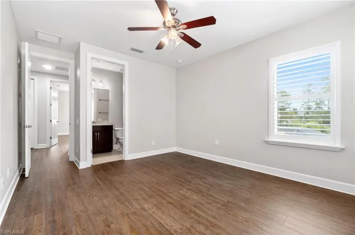 Unfurnished dual en-suite bedroom 2 with dark hardwood / wood-style floors, ensuite bathroom