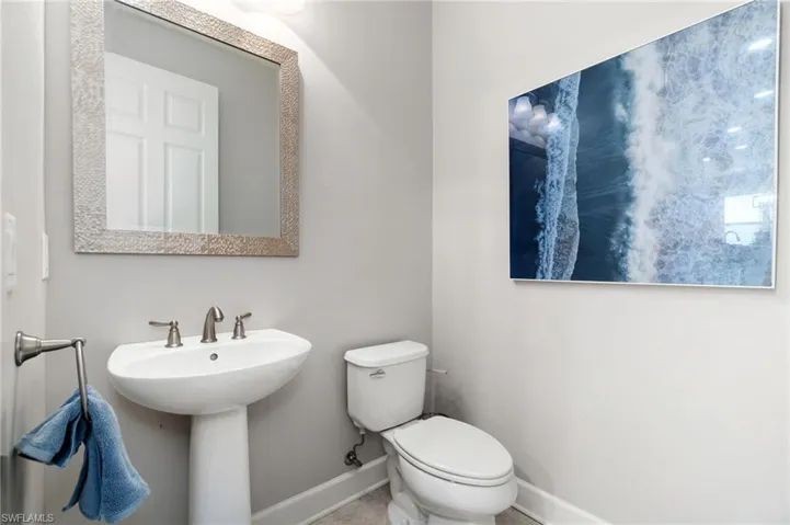 Guest half bath servicing the pool and downstairs entertaining. Centrally located.