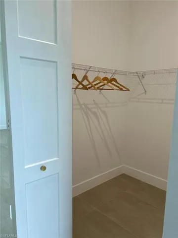 Spacious closet featuring tile patterned flooring