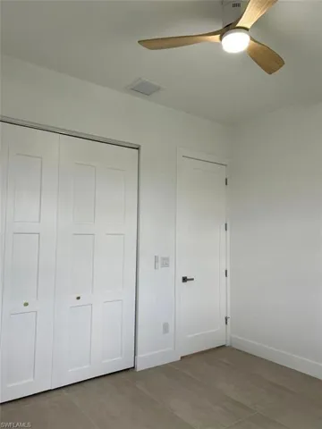 Unfurnished bedroom with ceiling fan