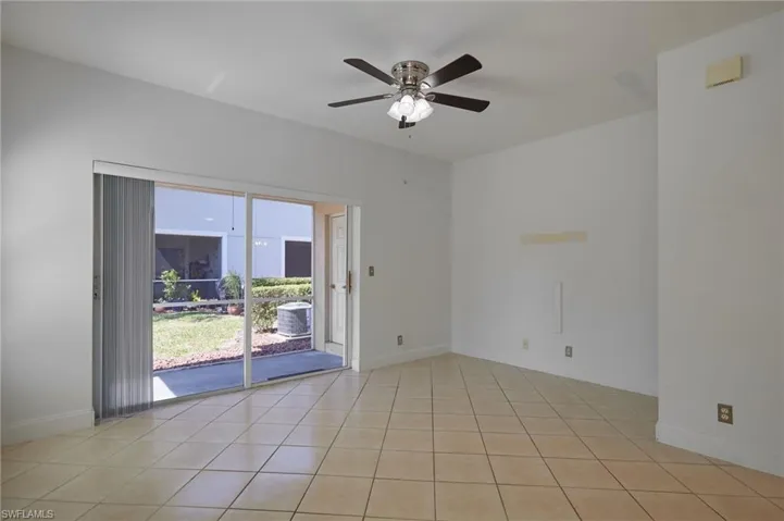 Unfurnished room with light tile patterned floors, ceiling fan, and baseboards