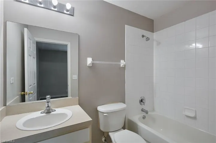 Full bathroom featuring shower / tub combination, vanity, and toilet