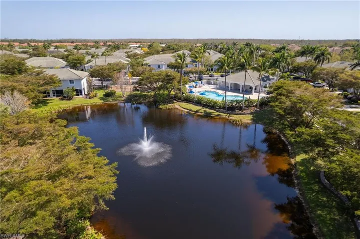 Birds eye view of property featuring a water view and a residential view