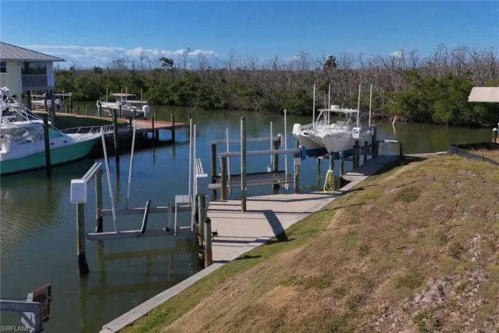 Dock featuring boat lift and a water view