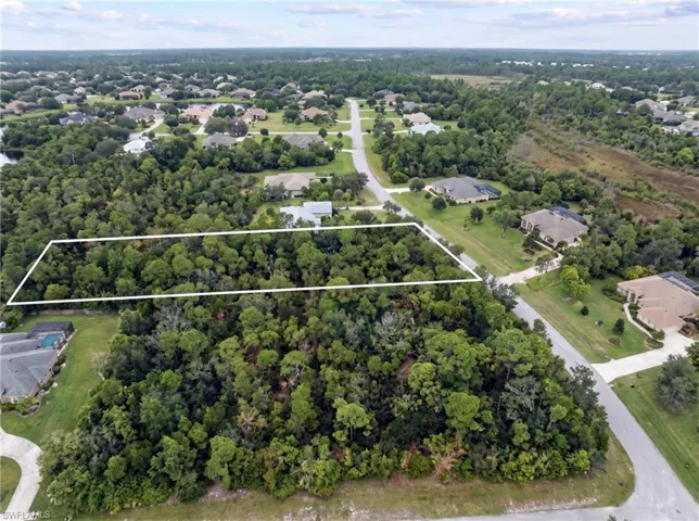 Wooded lot bordered by established residential properties and roadways