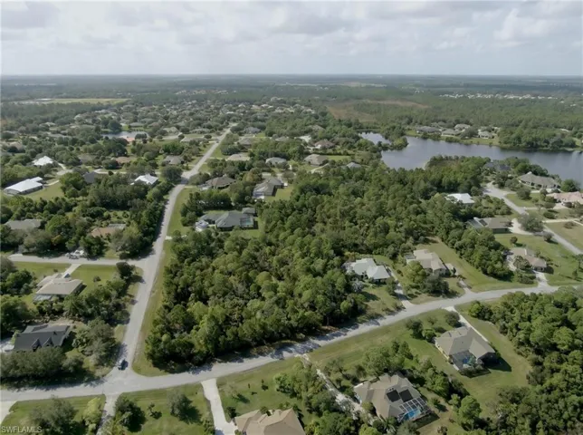 Expansive residential area featuring established homes, mature trees, and a nearby body of water