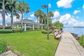 View of property's community with a water view and a yard