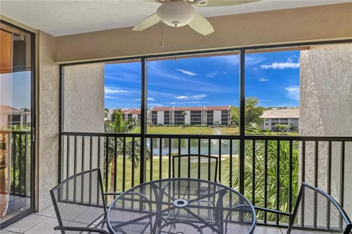 Unfurnished sunroom with a water view and ceiling fan