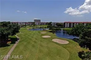 View of community with a lawn and a water view