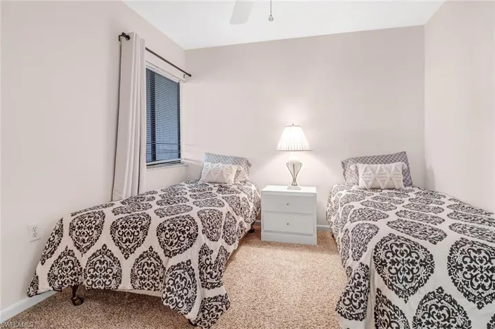 Carpeted bedroom with ceiling fan