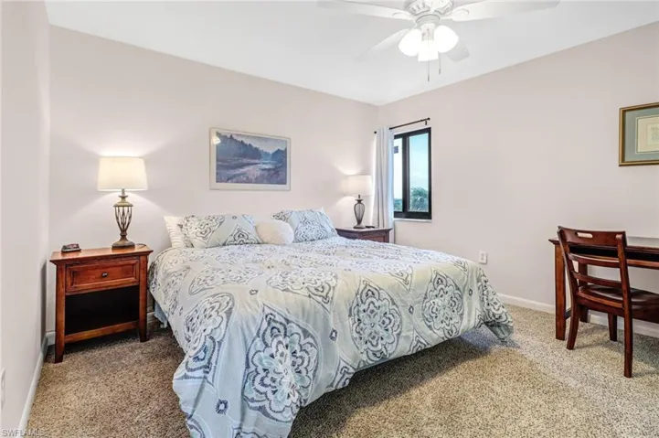 Bedroom featuring ceiling fan and carpet floors