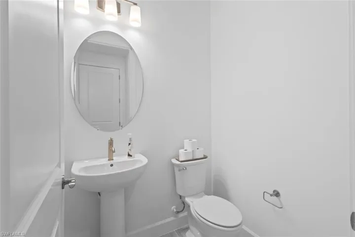 Bathroom with toilet and baseboards