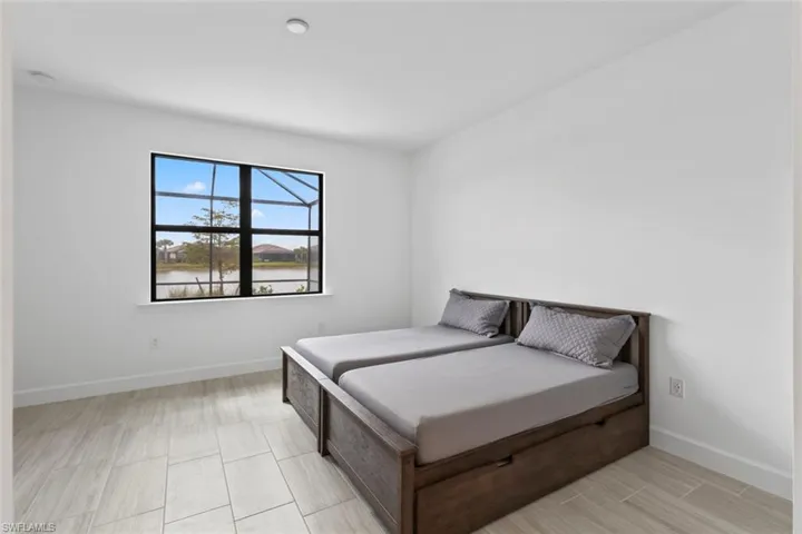 Bedroom featuring wood tiled floors and a water view