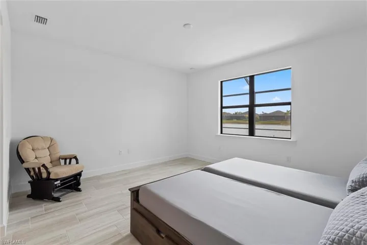 Bedroom with wood finish floors and baseboards