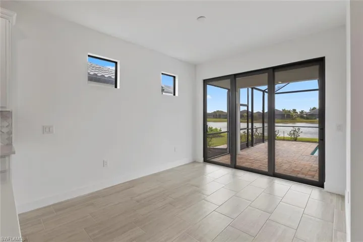 Unfurnished room with a water view and wood tiled floors