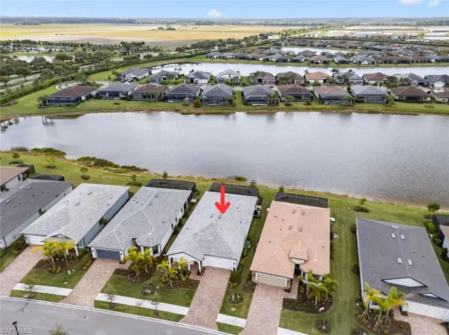 Aerial view of residential area featuring a nearby body of water