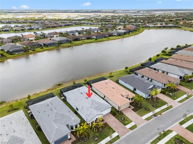 Aerial perspective of suburban area featuring a large body of water
