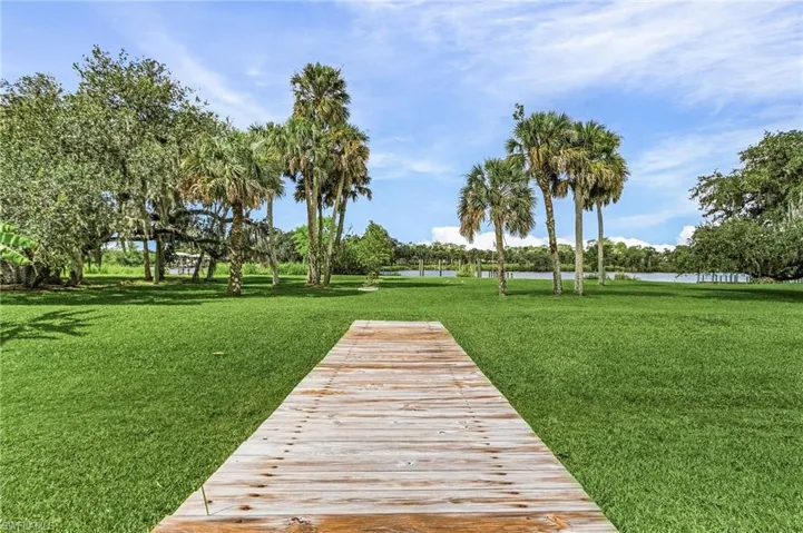 View of community with a water view and a lawn