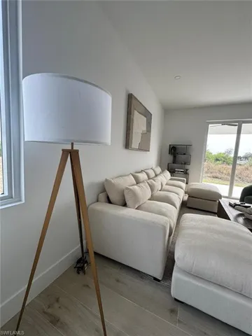 Neutral-toned walls complement the wood-finish flooring