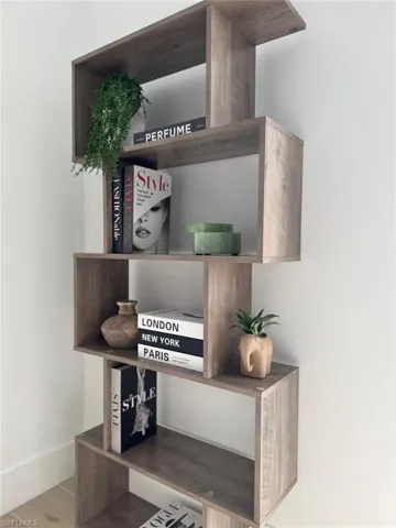 Floor-standing shelving unit featuring a wood-finish, multi-level design with open compartments