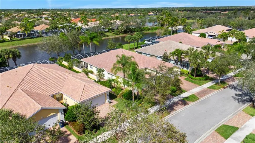 Birds eye view of property with a water view