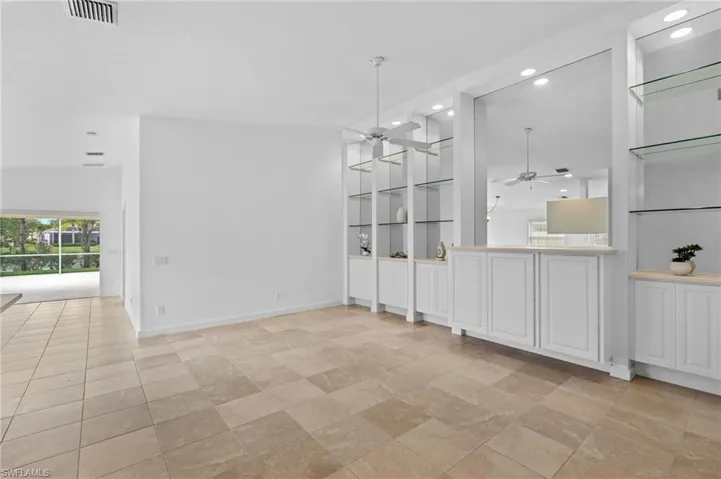 Unfurnished dining area with built in shelves and ceiling fan