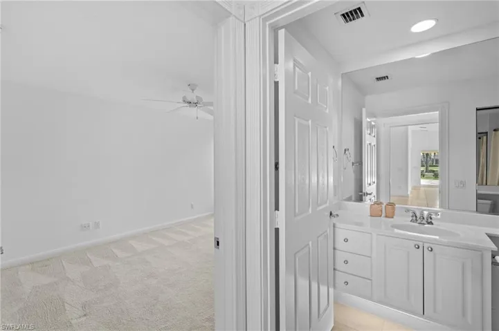 Bathroom featuring vanity and ceiling fan